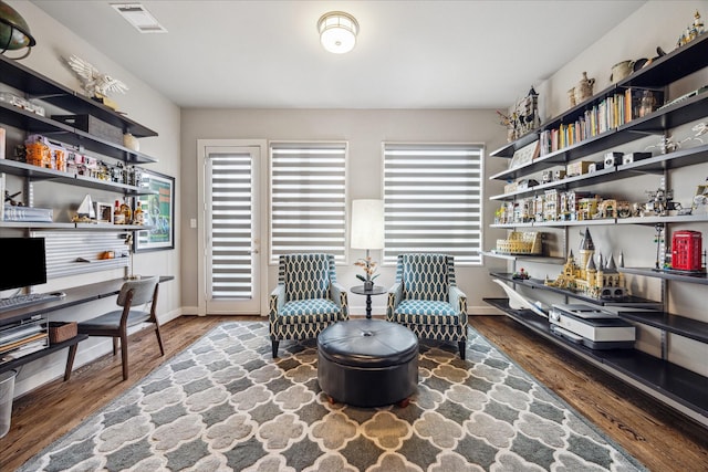 2707 Rusk St, Houston, TX 77003 - sitting room with plenty of natural light, wood finished floors, and baseboards