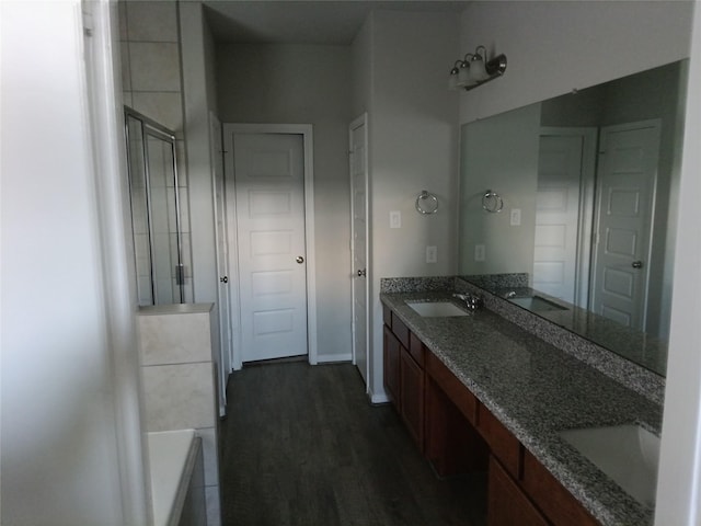 3619 Dry Creek Dr, Missouri City, TX 77459 - full bath with double vanity, an enclosed shower, a tub, and wood finished floors