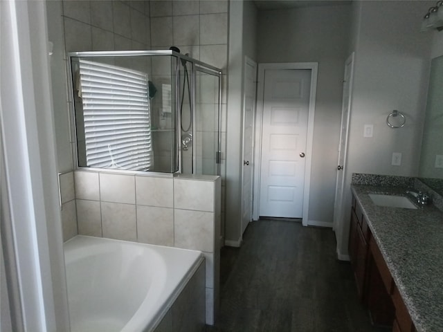 3619 Dry Creek Dr, Missouri City, TX 77459 - bathroom with a stall shower, vanity, a bath, baseboards, and wood finished floors