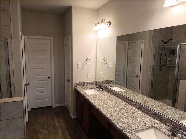 3619 Dry Creek Dr, Missouri City, TX 77459 - full bathroom featuring double vanity, a shower stall, and wood finished floors
