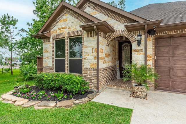 2323 Foley Rd, Crosby, TX 77532 - view of exterior entry featuring stone siding, a garage, a shingled roof, and concrete driveway