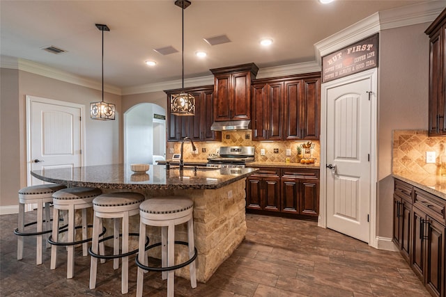 2323 Foley Rd, Crosby, TX 77532 - kitchen featuring stainless steel electric range oven, a kitchen breakfast bar, under cabinet range hood, tasteful backsplash, and dark stone countertops