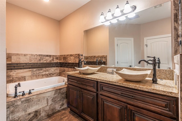 2323 Foley Rd, Crosby, TX 77532 - bathroom featuring double vanity, a bath, and wood finished floors