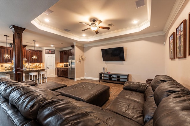 2323 Foley Rd, Crosby, TX 77532 - living area with a raised ceiling, ceiling fan, decorative columns, and ornamental molding