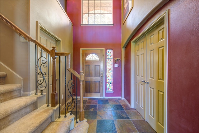 19902 Dayton Ridge Ln, Cypress, TX 77433 - foyer entrance featuring stairway, stone finish flooring, plenty of natural light, baseboards, and a towering ceiling