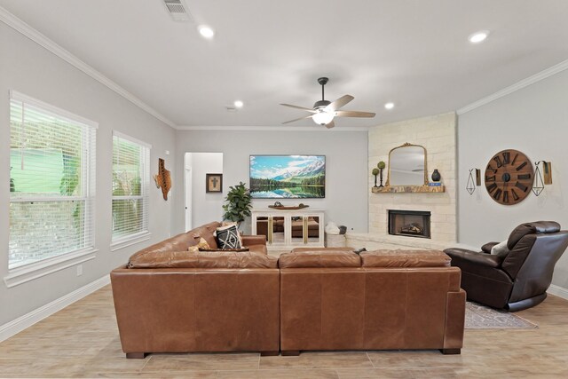 1603 Country Club Dr, Crosby, TX 77532 - living room with ornamental molding, a ceiling fan, a stone fireplace, baseboards, and light wood-type flooring