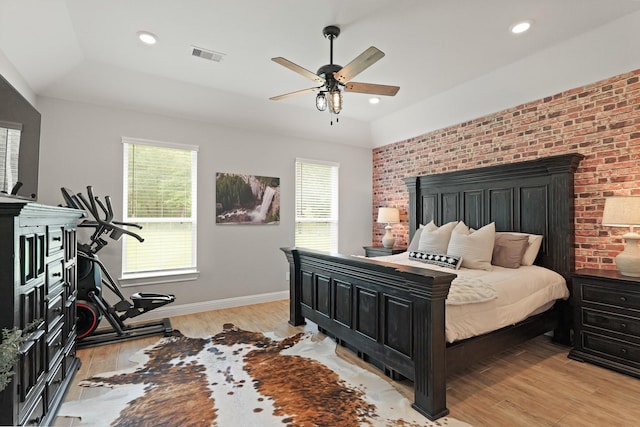 1603 Country Club Dr, Crosby, TX 77532 - bedroom featuring multiple windows, baseboards, light wood finished floors, brick wall, and recessed lighting