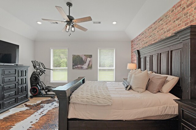 1603 Country Club Dr, Crosby, TX 77532 - bedroom with light wood-type flooring, brick wall, vaulted ceiling, a ceiling fan, and recessed lighting