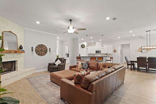 1603 Country Club Dr, Crosby, TX 77532 - living room featuring a ceiling fan, recessed lighting, light wood-type flooring, a fireplace, and crown molding
