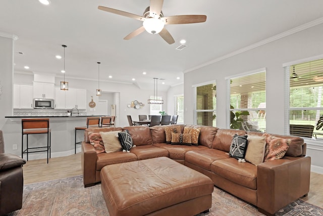 1603 Country Club Dr, Crosby, TX 77532 - living area with light wood-style flooring, plenty of natural light, ornamental molding, recessed lighting, and ceiling fan