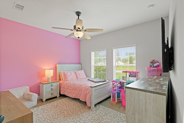 1603 Country Club Dr, Crosby, TX 77532 - bedroom with light wood finished floors and a ceiling fan