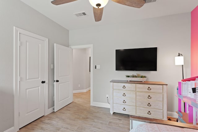 1603 Country Club Dr, Crosby, TX 77532 - bedroom with baseboards, light wood-style floors, and a ceiling fan