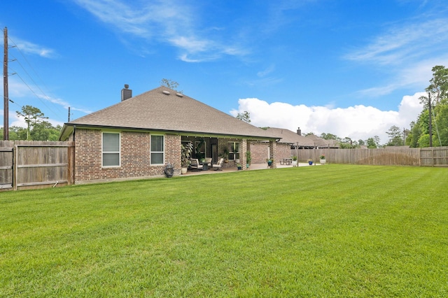 1603 Country Club Dr, Crosby, TX 77532 - rear view of house with brick siding, a shingled roof, a chimney, and a patio