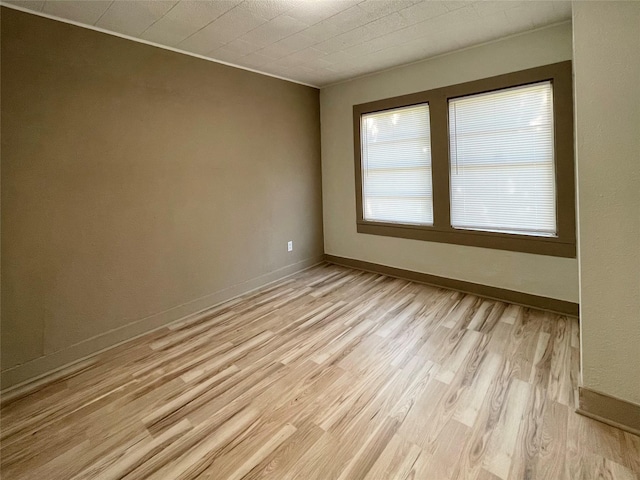1602 W Blum St, Alvin, TX 77511 - spare room featuring light wood-style flooring and baseboards