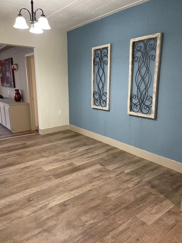 1602 W Blum St, Alvin, TX 77511 - empty room with a chandelier and wood finished floors