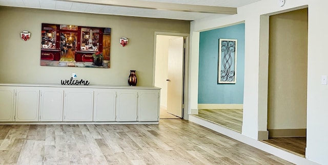 1602 W Blum St, Alvin, TX 77511 - bar area with light wood-type flooring, baseboards, and beam ceiling