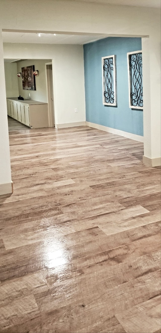 1602 W Blum St, Alvin, TX 77511 - empty room featuring light wood-style floors and baseboards