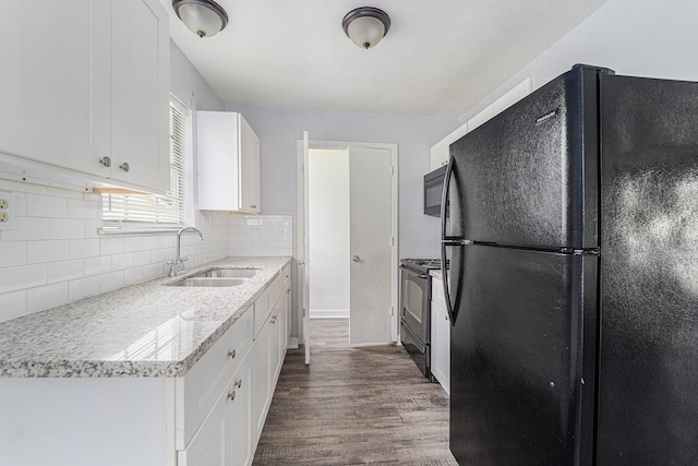 3517 Sparrow St, Houston, TX 77051 - kitchen with black appliances, a sink, dark wood-style floors, and white cabinetry
