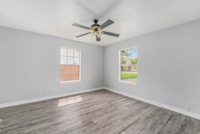 3517 Sparrow St, Houston, TX 77051 - empty room featuring dark wood-style flooring, a ceiling fan, and baseboards