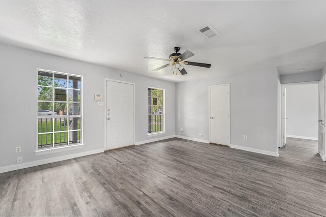 3517 Sparrow St, Houston, TX 77051 - empty room with plenty of natural light, ceiling fan, wood finished floors, and a textured ceiling