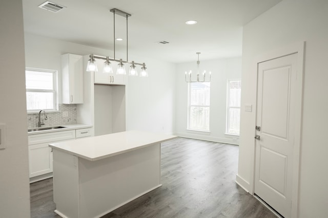 3405 Rebecca St, Houston, TX 77021 - kitchen with a sink, a chandelier, white cabinetry, a kitchen island, and recessed lighting
