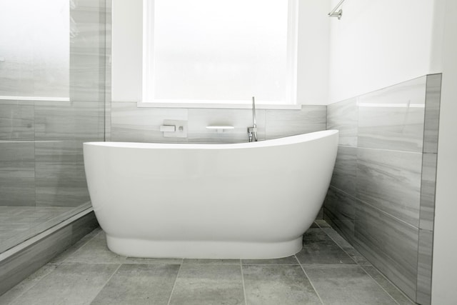 3405 Rebecca St, Houston, TX 77021 - full bathroom with a freestanding tub, tile walls, and a wainscoted wall