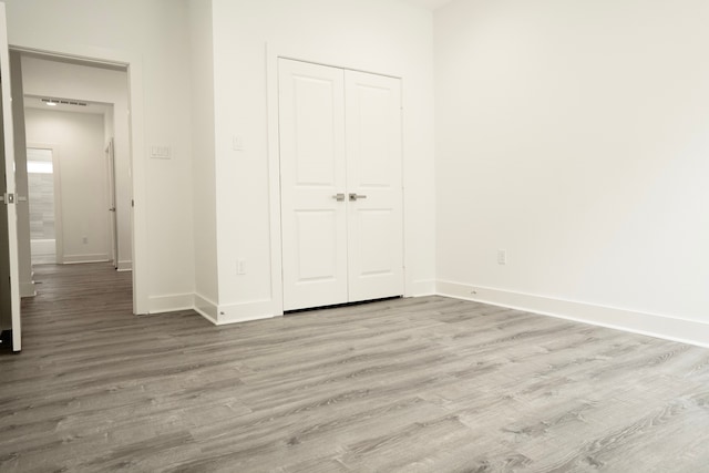 3405 Rebecca St, Houston, TX 77021 - unfurnished bedroom with wood finished floors, baseboards, and a closet