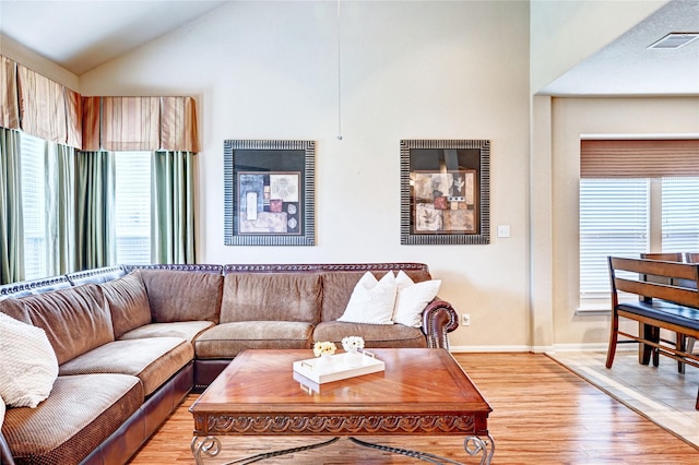 5838 Deleon Trail Dr, Spring, TX 77379 - living area featuring light wood-style floors, lofted ceiling, and baseboards