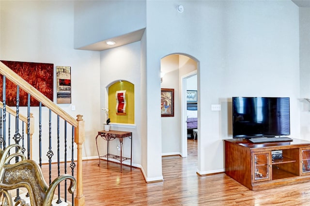 5838 Deleon Trail Dr, Spring, TX 77379 - foyer entrance featuring a high ceiling, wood finished floors, arched walkways, baseboards, and stairway