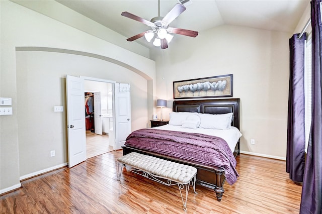 5838 Deleon Trail Dr, Spring, TX 77379 - bedroom featuring lofted ceiling, wood finished floors, arched walkways, baseboards, and a ceiling fan