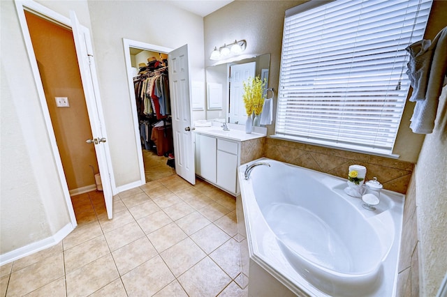 5838 Deleon Trail Dr, Spring, TX 77379 - full bathroom with a garden tub, vanity, a spacious closet, and tile patterned floors
