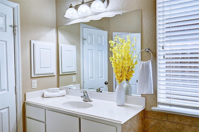 5838 Deleon Trail Dr, Spring, TX 77379 - bathroom featuring a textured wall and vanity
