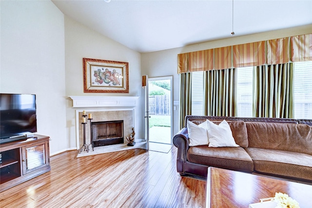 5838 Deleon Trail Dr, Spring, TX 77379 - living area featuring vaulted ceiling, wood finished floors, a fireplace, and baseboards