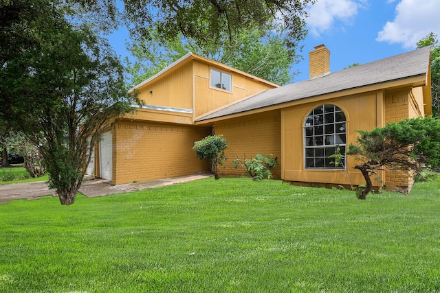 6814 Indian Falls Dr, Houston, TX 77489 - view of front of property featuring a chimney, a front yard, an attached garage, and brick siding