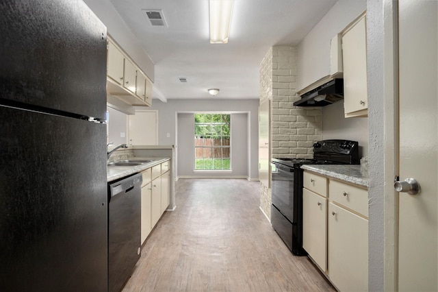 6814 Indian Falls Dr, Houston, TX 77489 - kitchen featuring black appliances, light countertops, light wood-type flooring, a sink, and under cabinet range hood