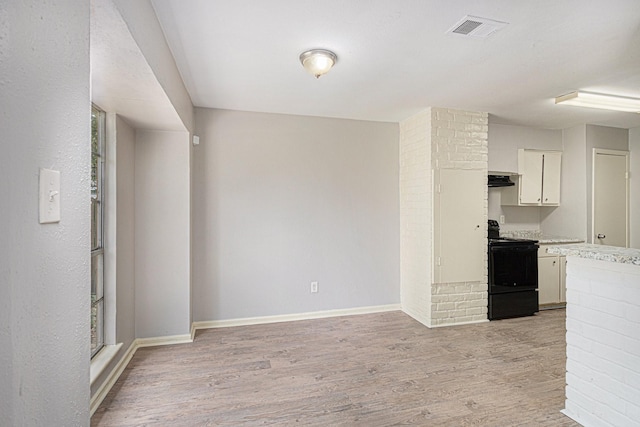 6814 Indian Falls Dr, Houston, TX 77489 - kitchen with black / electric stove, light wood-style flooring, light countertops, and baseboards