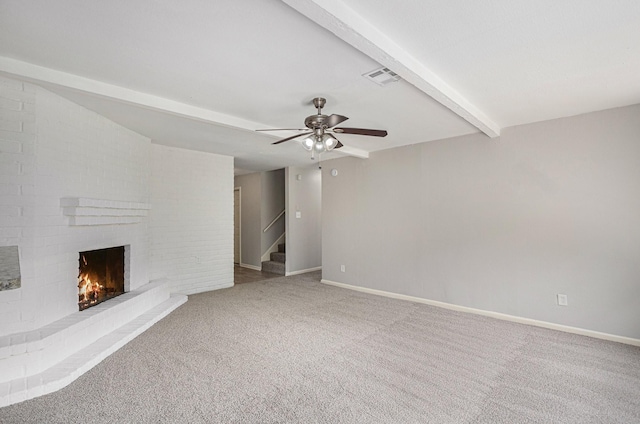 6814 Indian Falls Dr, Houston, TX 77489 - unfurnished living room featuring beam ceiling, a ceiling fan, a brick fireplace, baseboards, and carpet