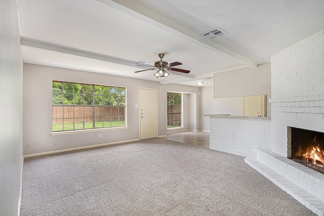 6814 Indian Falls Dr, Houston, TX 77489 - unfurnished living room with carpet, beam ceiling, a fireplace, baseboards, and ceiling fan