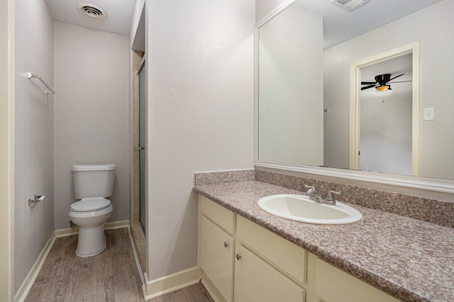 6814 Indian Falls Dr, Houston, TX 77489 - bathroom with wood finished floors, vanity, toilet, an enclosed shower, and ceiling fan
