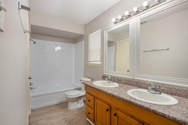6814 Indian Falls Dr, Houston, TX 77489 - full bathroom featuring double vanity, toilet, wood finished floors, and shower / bath combination