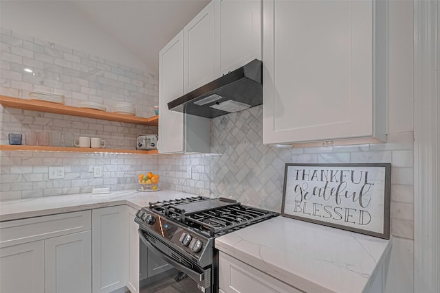 22 Tallow Hill Pl, Spring, TX 77382 - kitchen featuring under cabinet range hood, gas range oven, lofted ceiling, white cabinets, and tasteful backsplash
