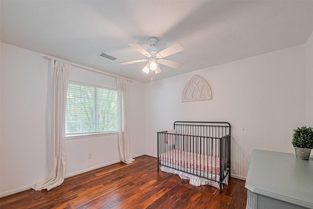 22 Tallow Hill Pl, Spring, TX 77382 - bedroom with wood finished floors, a ceiling fan, baseboards, and a crib