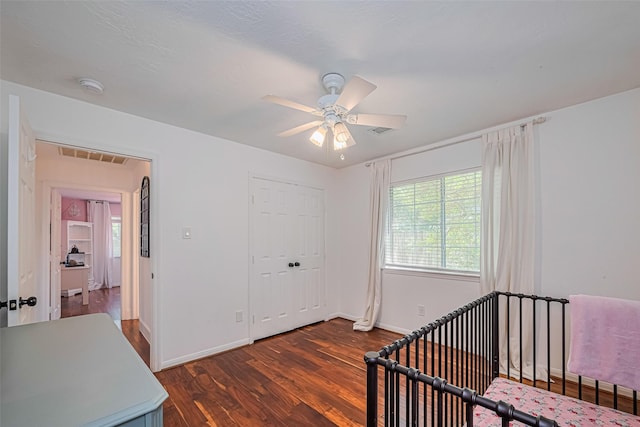 22 Tallow Hill Pl, Spring, TX 77382 - bedroom with dark wood-type flooring, baseboards, ceiling fan, and a nursery area
