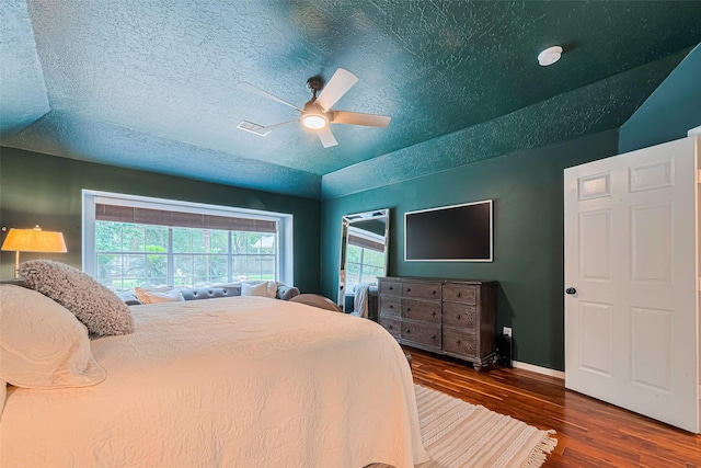 22 Tallow Hill Pl, Spring, TX 77382 - bedroom with wood finished floors, baseboards, ceiling fan, and a textured ceiling