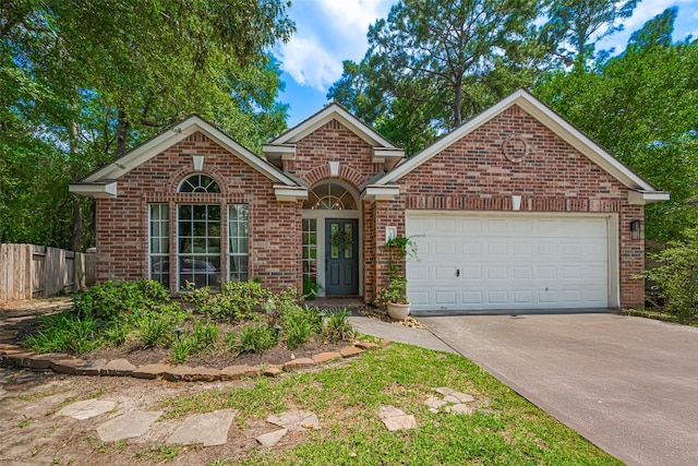 22 Tallow Hill Pl, Spring, TX 77382 - traditional-style home featuring brick siding, concrete driveway, and an attached garage