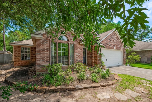 22 Tallow Hill Pl, Spring, TX 77382 - traditional-style house featuring brick siding, an attached garage, concrete driveway, and a shingled roof