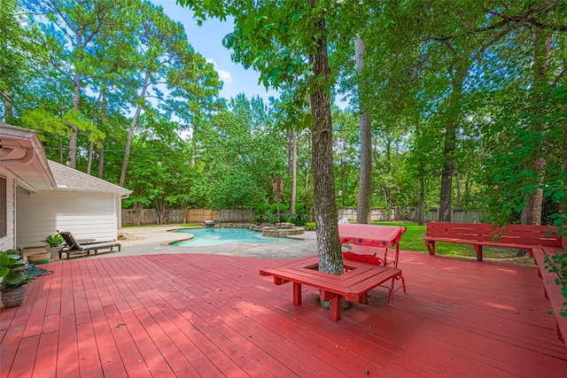 22 Tallow Hill Pl, Spring, TX 77382 - wooden deck featuring a fenced backyard, a pool with connected hot tub, and view of scattered trees