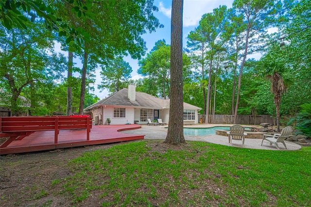 22 Tallow Hill Pl, Spring, TX 77382 - rear view of house featuring a deck, a patio area, an outdoor fire pit, and a chimney