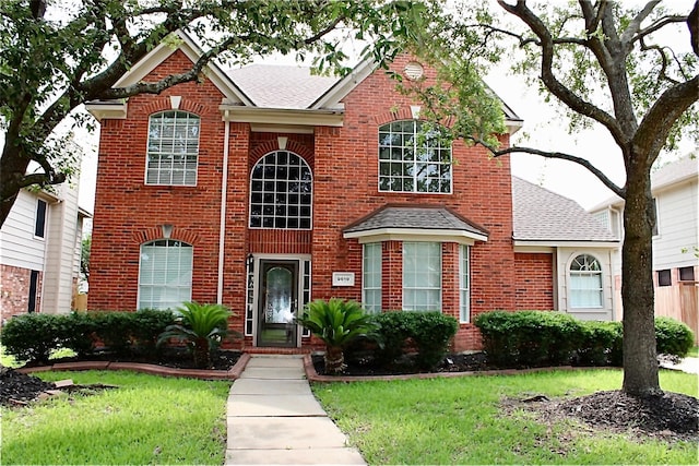 9619 Therrell Dr, Houston, TX 77064 - view of front of property with roof with shingles, brick siding, and a front yard