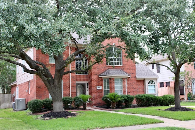 9619 Therrell Dr, Houston, TX 77064 - traditional-style house with brick siding, central AC unit, and roof with shingles